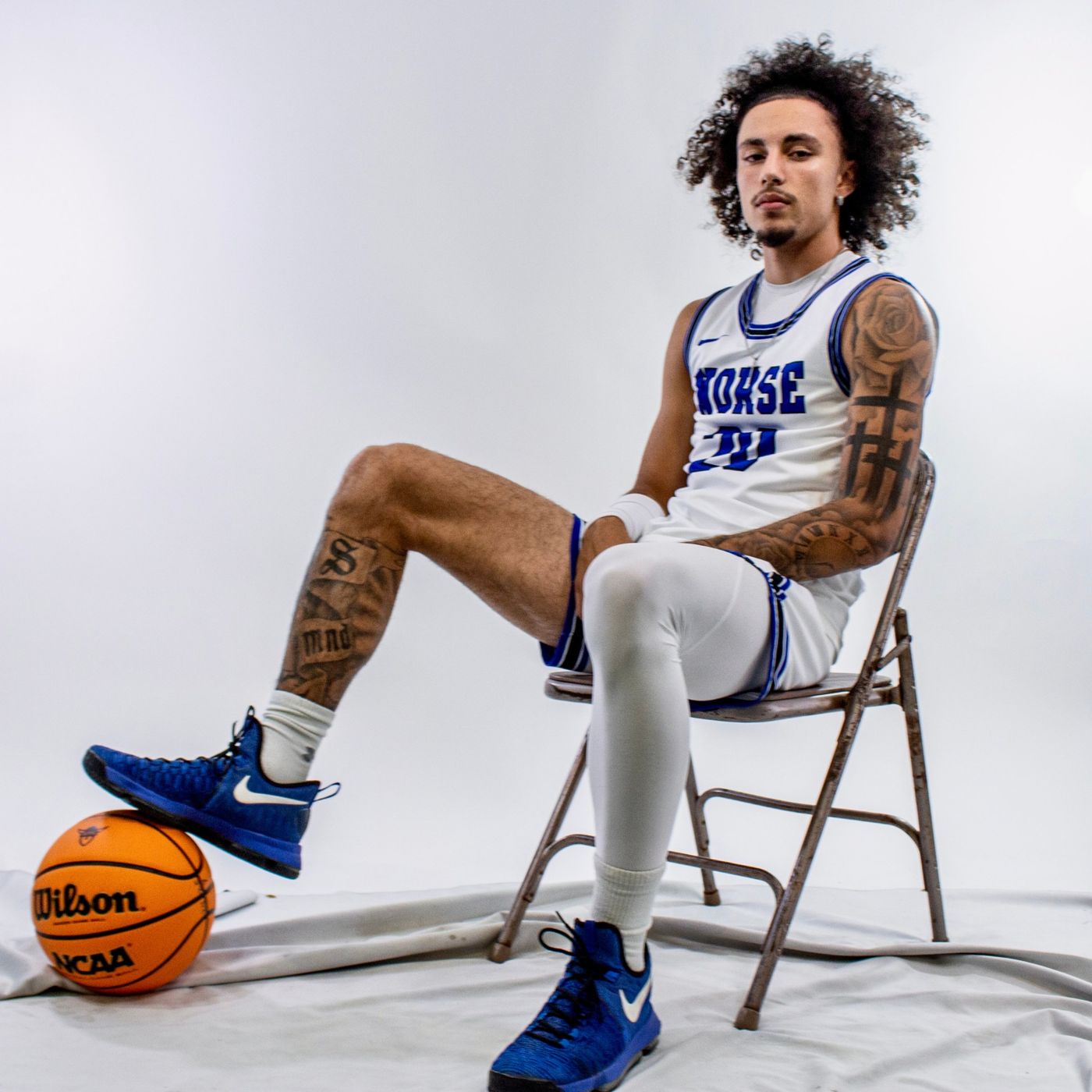 Kyanu seated on a folding chair, foot on a ball